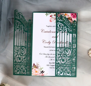 Macro view of laser-cut floral gate wedding invitation with elegant pink floral card