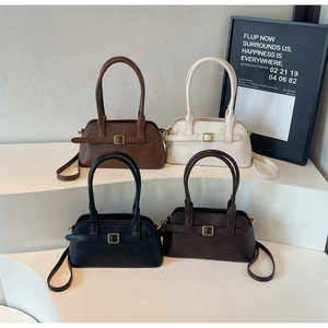 Close-up of minimalist retro leather shoulder bags in four colors with gold metal buckles