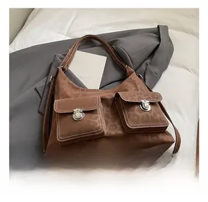 Detail of vintage brown leopard print tote with large dual front pockets and silver buckles