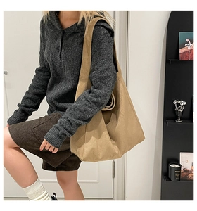 Detailed view of the large khaki tote bag featuring a soft texture and wide shoulder strap