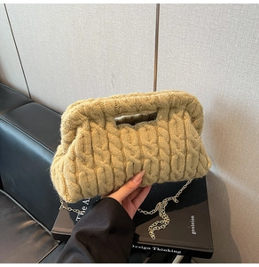 Close-up of olive green cable-knit texture and gold chain on the crossbody bag