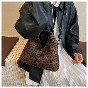 Detailed macro view of soft suede leopard print tote bag with leopard pattern texture