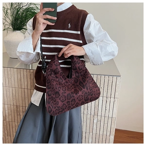 Close-up of leopard print tote bag with cutout handle in a stylish autumn setting