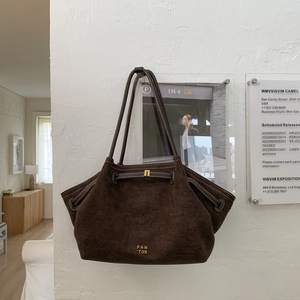 Minimalist deep brown matte leather tote bag with gold logo on a white background