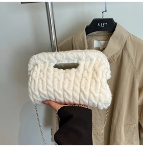 Close-up of white chunky knit handbag with cable weave texture and gold chain detail