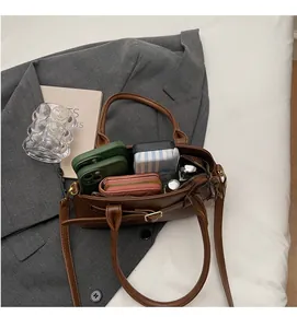 Spacious interior of brown leather shoulder bag showing ample storage for daily essentials