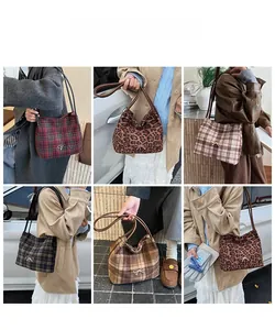 Detail of plaid bucket bag collection with golden bow accents and woolen texture