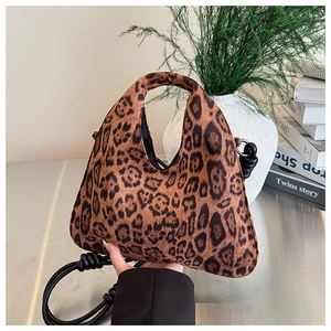 Detail view of leopard print tote bag with circular handle and knotted black strap
