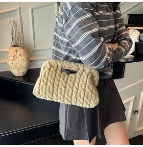 Detailed close-up of khaki chunky knit bag featuring textured cable stitch and gold chain strap