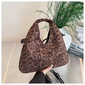 Close-up of leopard print tote bag fabric texture with soft suede feel and knotted strap