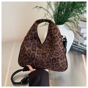 Close-up of leopard print tote bag featuring a knotted shoulder strap and plush texture