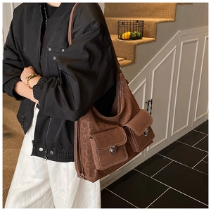 Detail view of large leopard print tote bag with dual front flap pockets and metal buckles