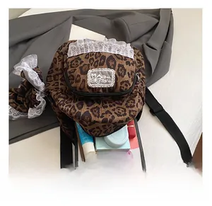 Detail view of leopard print backpack interior showing tablet and cosmetic storage