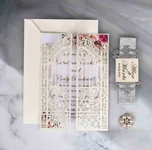 Detailed laser-cut wedding invitation set with floral inner page and glitter belly band