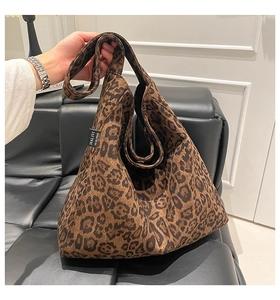 Detail of a large leopard print canvas tote bag with MALIVI label shown in hand