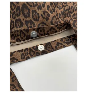 Detail of the leopard print canvas tote bag featuring a silver magnetic snap closure
