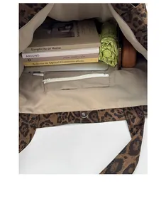 Interior view of leopard print tote bag showing spacious main compartment and zip pocket