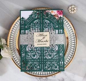 Detail of laser-cut gate wedding invitation in dark green with silver glitter band