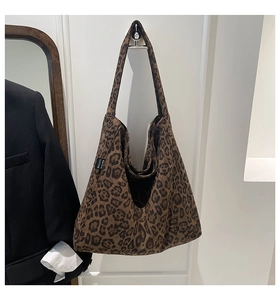 Detailed close-up of leopard print tote bag with thick matte fabric and wide shoulder strap
