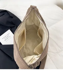 Detail view of large corduroy tote interior with beige lining and zip pocket
