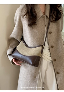 Detailed view of NO FILTER vintage suede and leather patchwork shoulder bag on a model