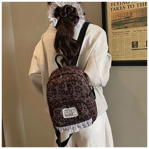 Leopard print canvas backpack set with matching lace scrunchie shown from a back view