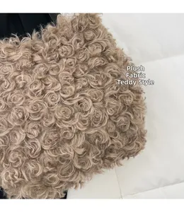 Close-up of brown plush teddy fabric with curly texture on a stylish bucket bag