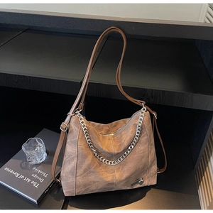 Detail of vintage brown tote bag with silver chain and adjustable shoulder strap