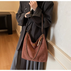 Brown suede hobo bag with vintage metal chain and wooden bead charm accessory