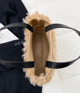 Top view of plush bucket bag showing open interior space and black leather handle detail