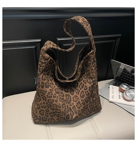 Detailed view of leopard print tote bag on a white bench in a stylish lifestyle setting