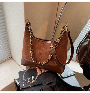 Detail of suede and smooth leather crossbody bag with chunky gold chain and leather strap