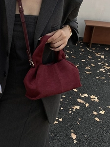 Vintage burgundy suede pleated bucket bag with adjustable strap and golden hardware