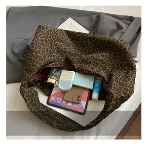Spacious leopard print tote bag showing organized interior with iPad and beauty essentials