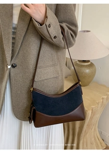 Minimalist navy blue suede and brown leather retro shoulder bag shown in an elegant outfit