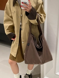 British style large plaid tote bag in dark brown suede on a model with neutral background