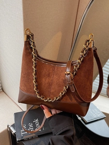 Brown suede and leather patchwork hobo bag with a stylish metal chain and long strap