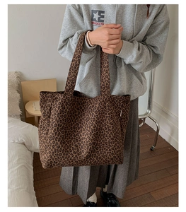 Detailed close-up of leopard print canvas tote bag showing thick fabric texture and pattern