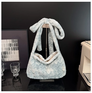 Detail of light blue plush handbag with cloud texture and magnetic closure