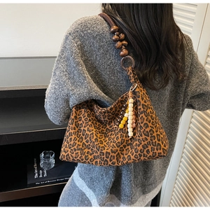 Detail der Leopard-Hobo-Tasche mit Schultergurt aus Holzperlen und bunten Anhängern