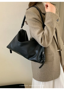 Macro detail of black lychee texture leather tote with premium silver zipper hardware