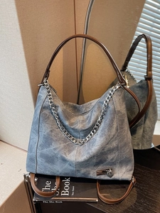 Retro denim blue tote bag with brown leather handles and silver heart charm decoration