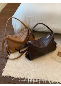 Close-up of minimalist retro tote bags in camel and brown lychee grain leather