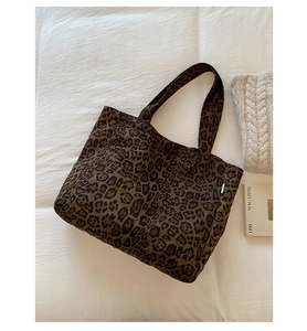 Close-up of leopard print canvas tote bag with wide straps on a white background
