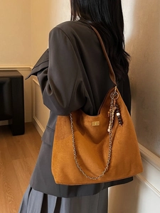 Retro brown suede hobo shoulder bag featuring golden lock and beaded chain accessories