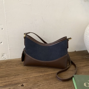 Detail of vintage suede bucket bag featuring contrast colors and NO FILTER embossing