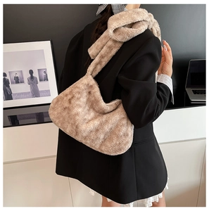 Faux fur shoulder bag in apricot shown on model to display its large capacity and soft texture