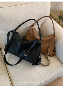 Detail of minimalist leather tote bags in black and brown with fine pebble texture