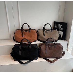 Collection of four oversized travel tote bags in earthy tones on marble pedestals