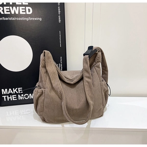 Detail of vintage brown corduroy tote bag showing soft ribbed texture and drawstring side pocket